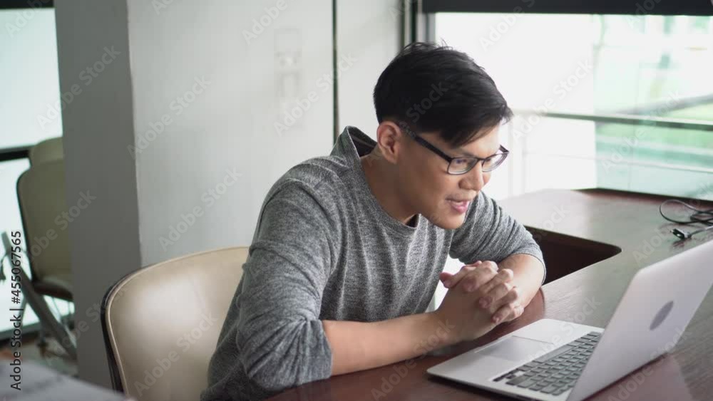 Asian young businessman using laptop computer video conference talking to colleagues meeting online work from home quarantine . teaching online lesson . video call consulting with clients or coworker Asian young businessman using laptop computer video conference talking to colleagues meeting online work from home quarantine . teaching online lesson . video call consulting with clients or coworker