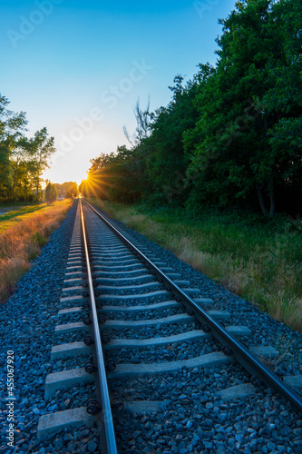 The train tracks and the sun's rays are falling beautifully.