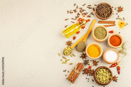 A set of spices for cooking curry. Aromatic condiments on light stone concrete background © FuzullHanum