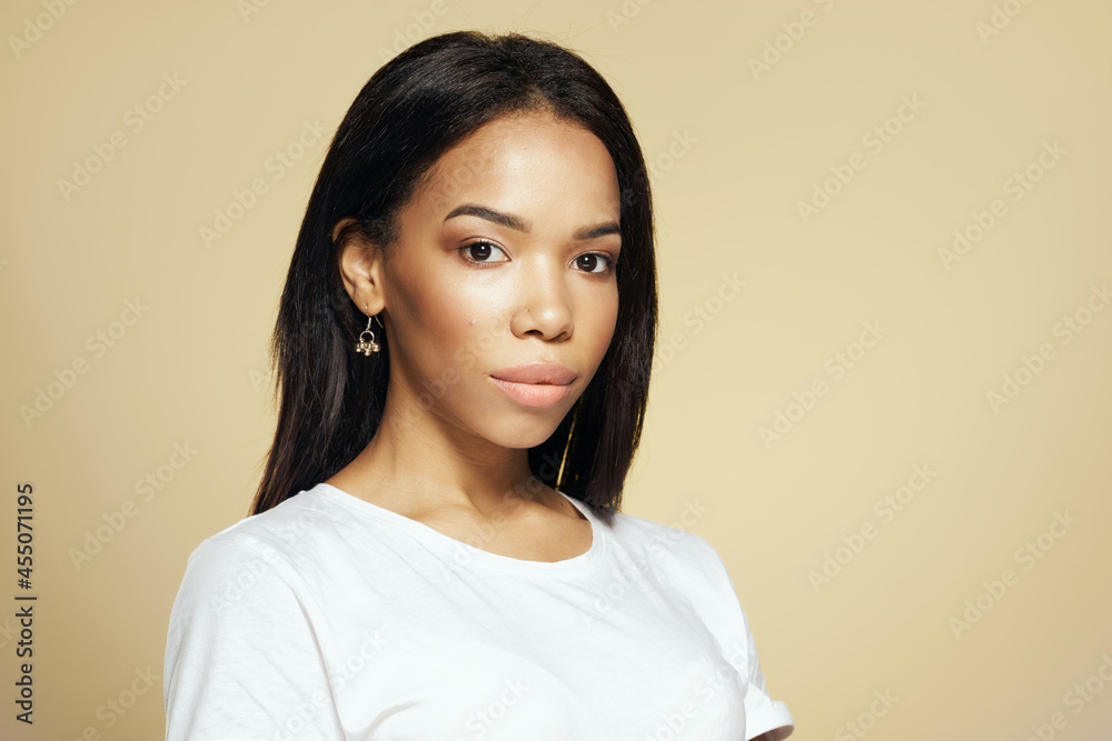 woman african appearance dark long hair cosmetics decoration beige background woman african appearance dark long hair cosmetics decoration beige background