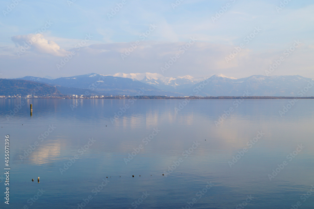 tranquil wintery lake Constance (Bodensee) with the snowy Alps in the background (Lindau in Germany)