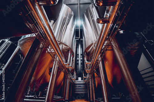 Rows of steel tanks for beer fermentation and maturation in a craft brewery photo