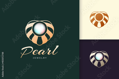 Luxury and elegant pearl with clam logo represent jewelry or gem fit for beauty and fashion brand