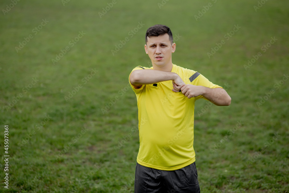 Soccer referee to point out a yellow card to a player in the soccer stadium Soccer referee to point out a yellow card to a player in the soccer stadium