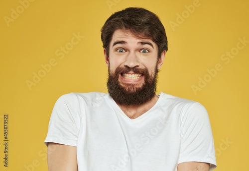 bearded man in a white t-shirt expressive look discontent close-up