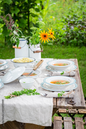 Fresh broth served in the garden. Soup in summer day.