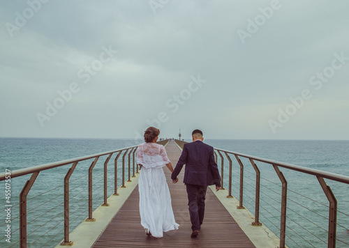 bride and groom on the pier