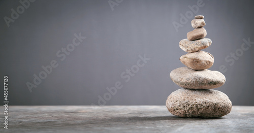 Balance stones on grey background.