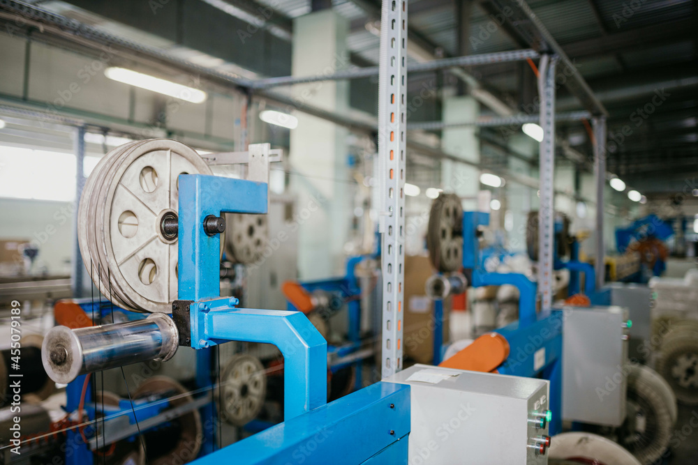 modern automated plant for the production of power electrical cables and optical fibers. A line of machine tools in a factory.