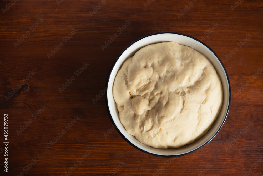 Process of raising the dough in a special basket. Dough made from natural sourdough. Wheat dough. Fermentation. Top view. Process of raising the dough in a special basket. Dough made from natural sourdough. Wheat dough. Fermentation. Top view.