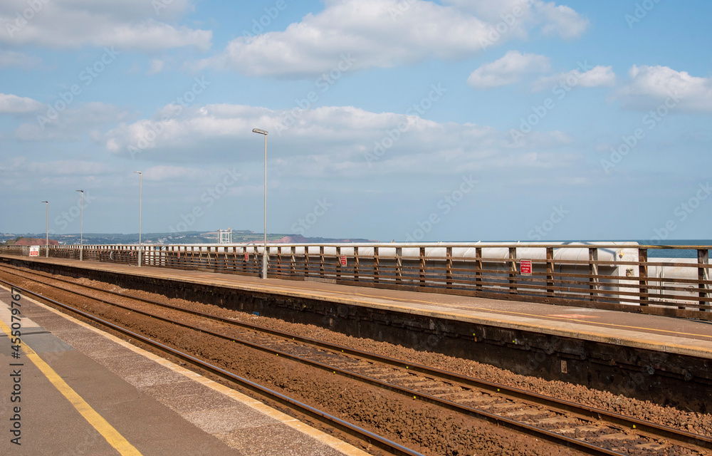 Devon, England, UK. 2021.  Railway tracks passing through a west country coastal station.