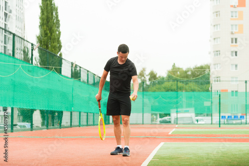 Tennis player getting ready to start playing on the tennis court. © yallowww