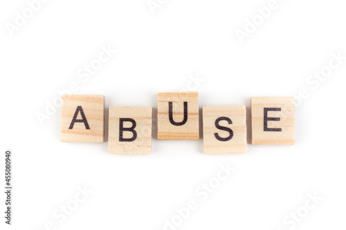 Abuse- word composed fromwooden blocks letters on White background, copy space for ad text.