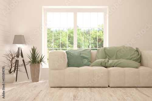 Stylish room in white color with sofa and summer landscape in window. Scandinavian interior design. 3D illustration