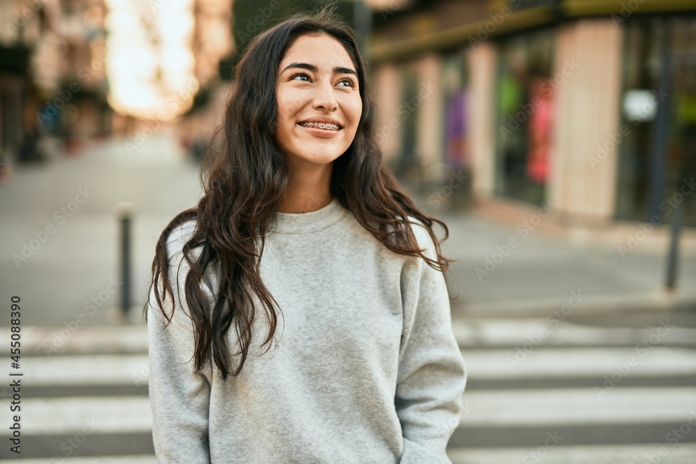 Young middle east girl smiling happy standing at the city. Young middle east girl smiling happy standing at the city.