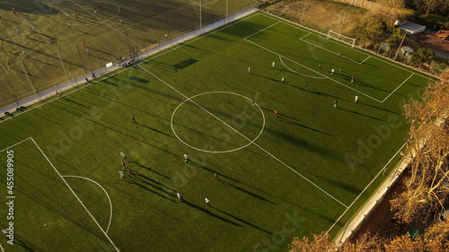 Birds eye view of players dribbling the football during championship match.