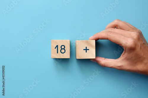 Wooden cubes with the inscription: 18+. The age limit for something. photo