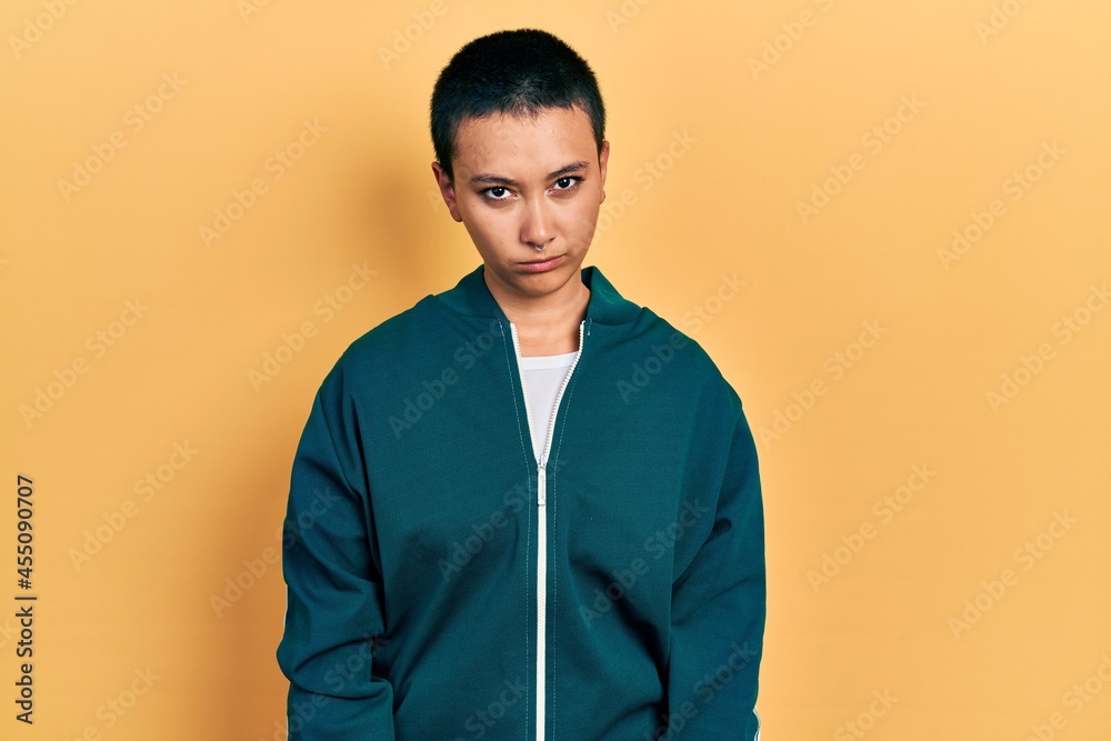 Beautiful hispanic woman with short hair wearing sporty jacket skeptic and nervous, frowning upset because of problem. negative person. Beautiful hispanic woman with short hair wearing sporty jacket skeptic and nervous, frowning upset because of problem. negative person.
