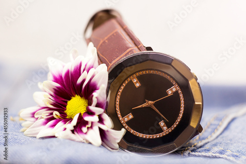 Wristwatches and lilac chrysanthemum so close photo