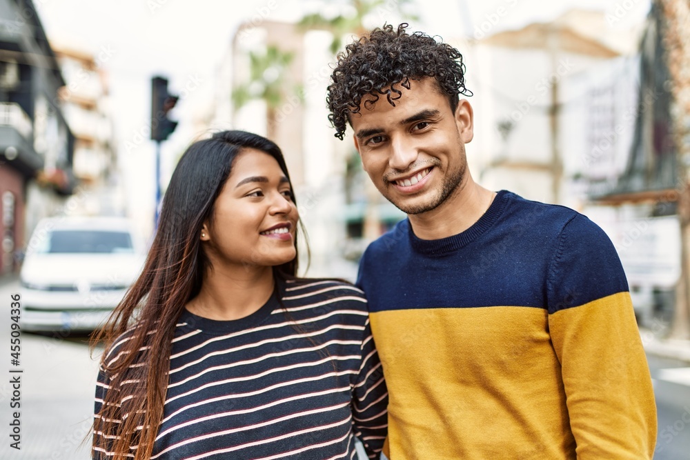 Young latin couple smiling happy and hugging at the city. Young latin couple smiling happy and hugging at the city.