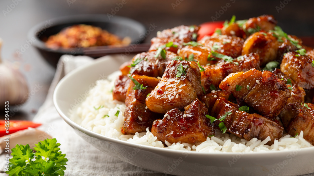 Chinese traditional cuisine sticky braised pork belly with rice on white plate