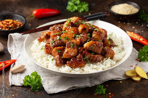 Chinese traditional cuisine sticky braised pork belly with rice on white plate photo