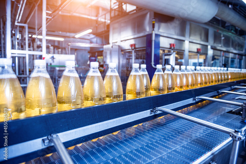 Conveyor belt with bottles for juice or water at a modern beverage plant