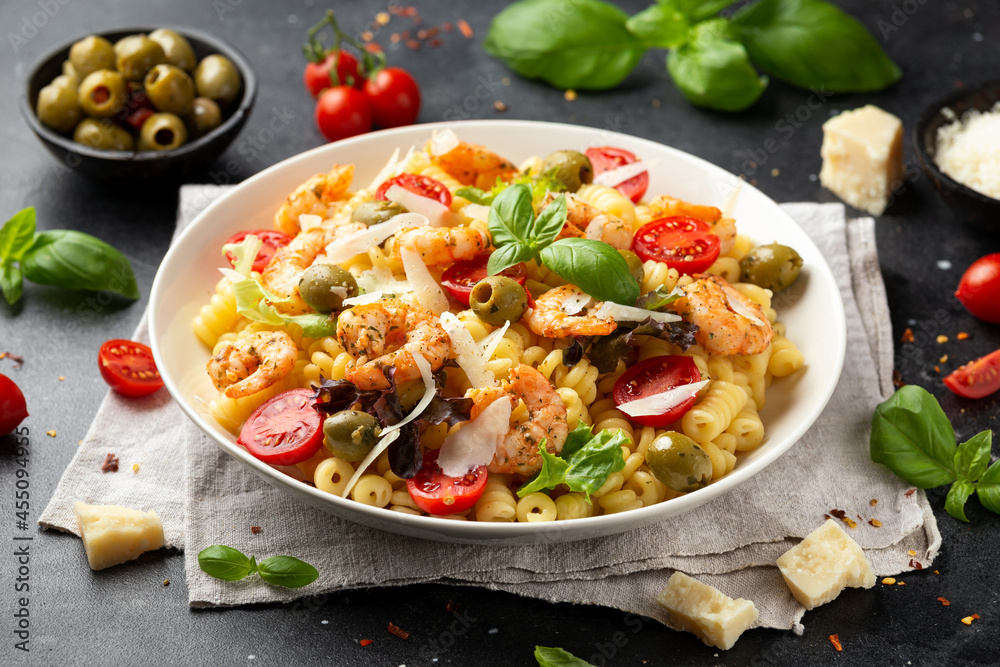 King prawn pasta salad with marinated green olives, cherry tomatoes and parmesan cheese shavings. Healthy food. King prawn pasta salad with marinated green olives, cherry tomatoes and parmesan cheese shavings. Healthy food.