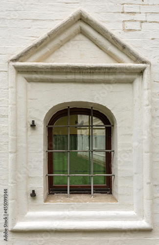 Window of an old brick building with iron bars