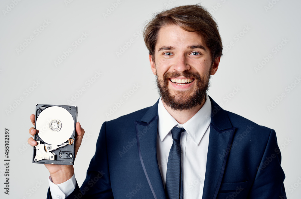 Cheerful business man with hard drive from computer data protection Cheerful business man with hard drive from computer data protection