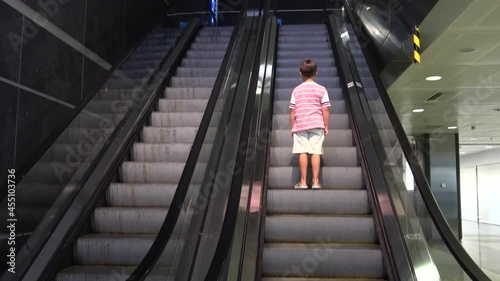 Sabiha Gokcen Airport, Istanbul, Turkey - 5th of August 2021: 4K Child travels on escalator in the airport
 photo
