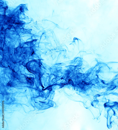 Blue smoke on a white background. © schankz