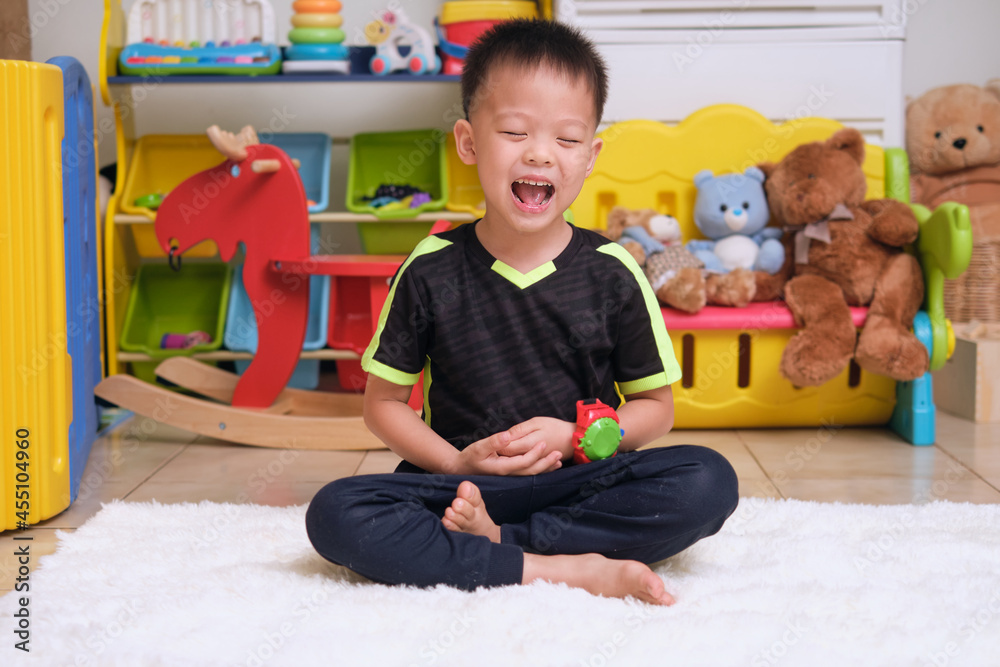 Little Asian kid with eyes closed, barefoot practices yoga and meditating to relieve negative emotions during quarantine at home, Beginner meditation, Breathing exercise for kids, Healthy lifestyle Little Asian kid with eyes closed, barefoot practices yoga and meditating to relieve negative emotions during quarantine at home, Beginner meditation, Breathing exercise for kids, Healthy lifestyle