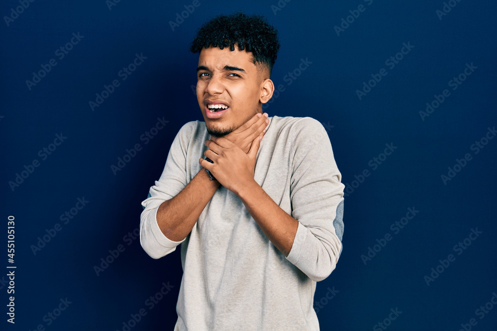 Young african american man wearing casual clothes shouting and suffocate because painful strangle. health problem. asphyxiate and suicide concept.