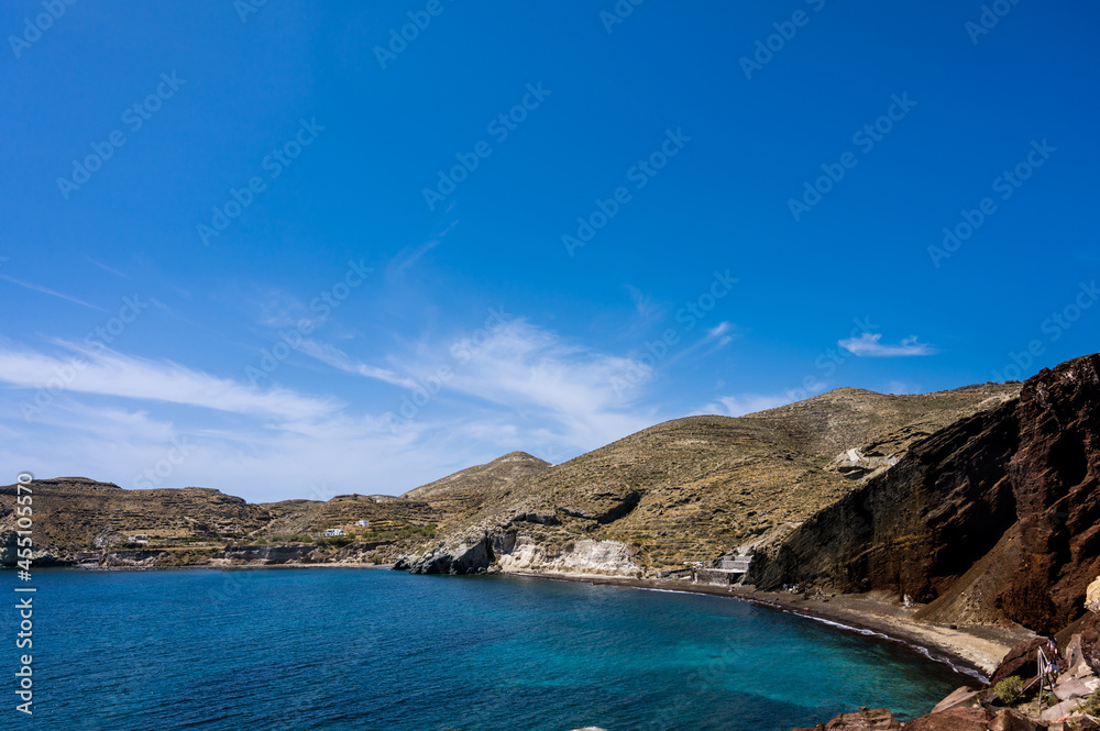 Scenic landscape of red sand beach near Akrotiri village on Santorini island, Greece. Huge stones and rocks. Aegean Sea, Cyclades. Beautiful nature.