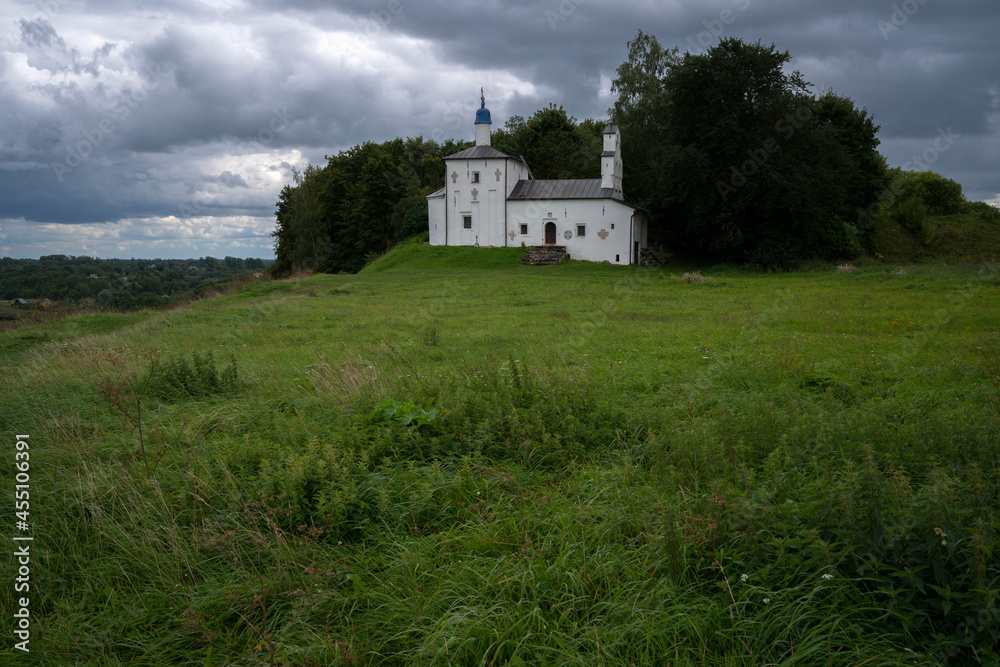 Saint Nicholas Church in Gorodishche  (Nikolskaya church) on Truvorov Gorodishche on a cloudy summer evening. Stary Izborsk, Pskov region, Russia