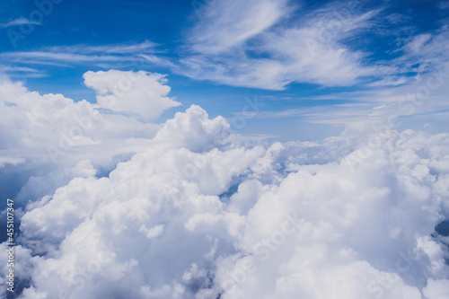 Aerial view of fluffy clouds and clear blue bright sky background in sunny day
