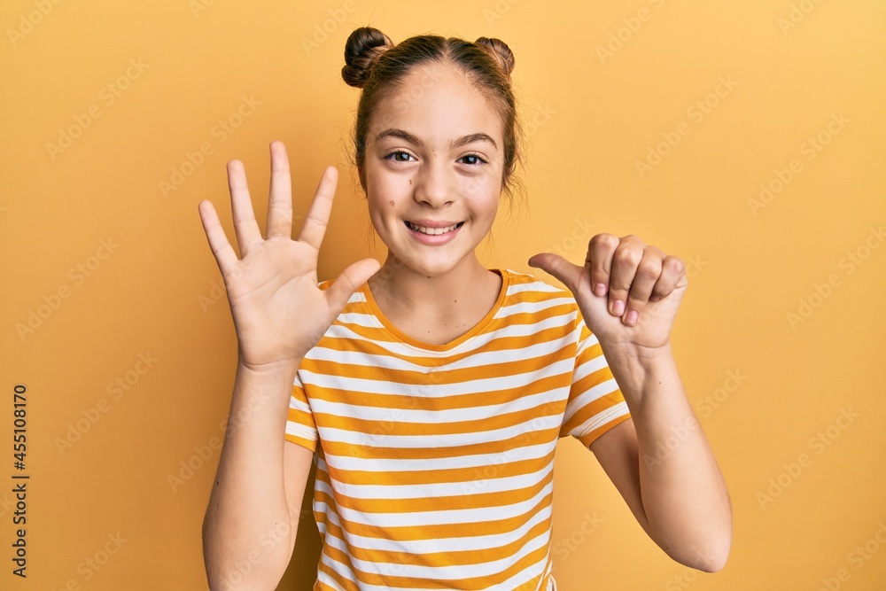 Beautiful brunette little girl wearing casual striped t shirt showing and pointing up with fingers number six while smiling confident and happy. Beautiful brunette little girl wearing casual striped t shirt showing and pointing up with fingers number six while smiling confident and happy.