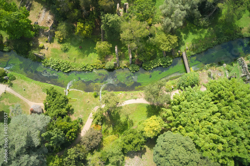 aerial view of the watercourse that crosses the gardens of ninfa in the country of cisterna di latina
