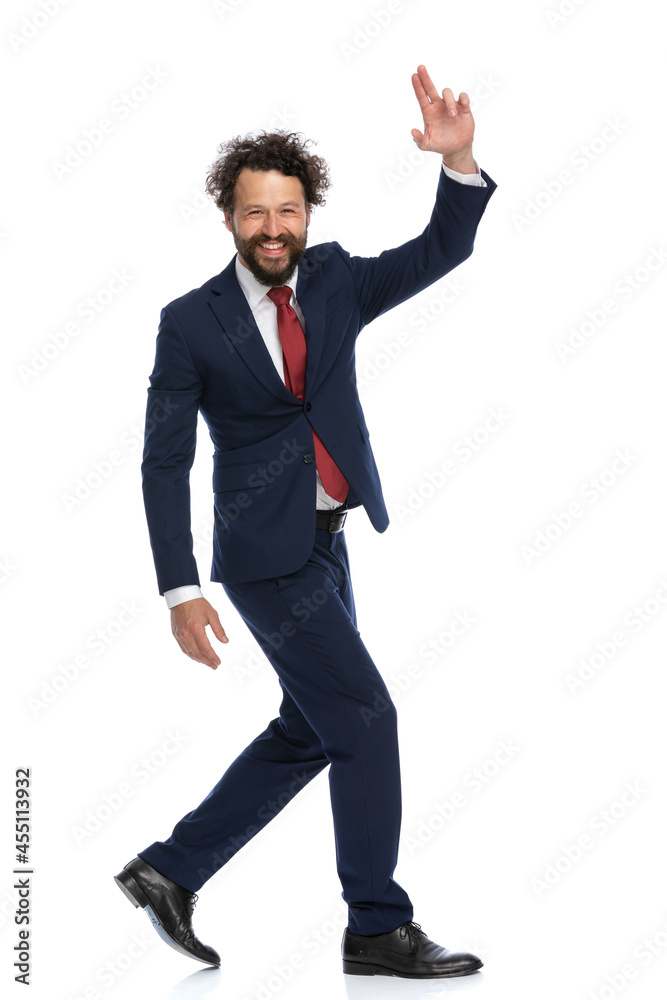 happy businessman walking to side, saluting and smiling happy businessman walking to side, saluting and smiling