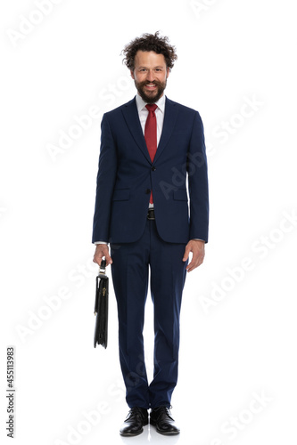 handsome businessman standing against white background with a briefcase