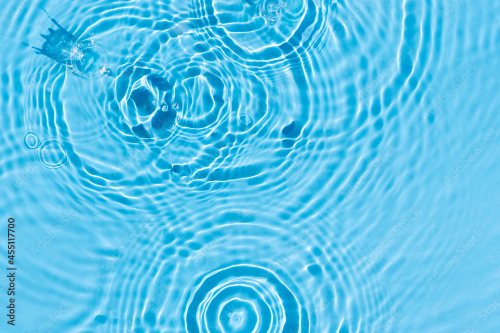 Bursts on blue water under sunlight. Top view, flat lay Bursts on blue water under sunlight. Top view, flat lay
