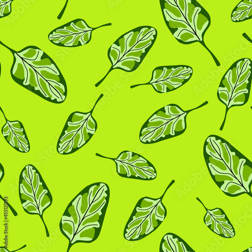 Seamless pattern Spinach salad on bright green background. Modern ornament with lettuce.