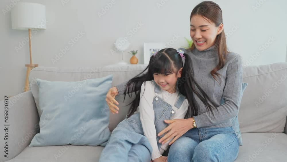 Portrait of Asian happy mother sit with young girl daughter in house. Portrait of Asian happy mother sit with young girl daughter in house.