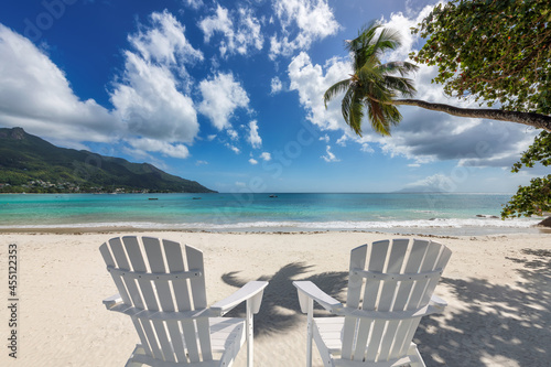 Sandy beach with beach chairs in tropical island