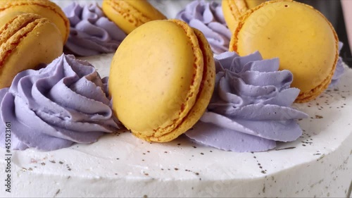 Professional confectioner decorating cake with french cookie - Macaroon. The process of cooking. 4K. Violet and orange. Close up. Step 3