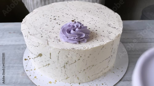 Professional confectioner decorating cake with cream rose. The process of cooking. 4K. Step 1