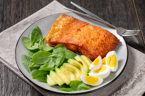 baked salmon fillet with eggs , spinach, avocado