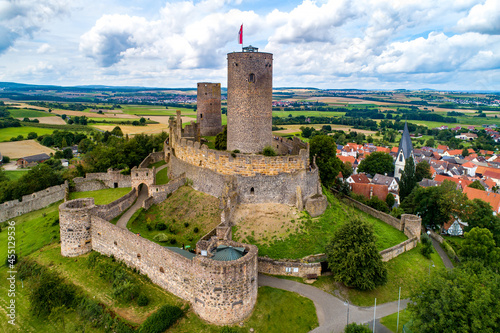 Ruin of medieval Münzenberg castle in Hesse, Germany. Built in12th century, one of the best preserved castles from the High Middle Ages in Germany. Summer, aerial view photo