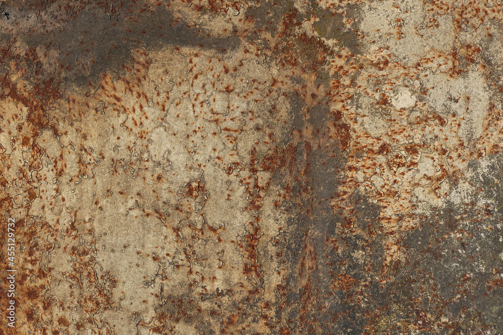 Fototapeta premium rusty metal surface with beige, black, gray, yellow and orange tones - worn irregular steampunk background with scratches and peeling paint looking like a creepy map